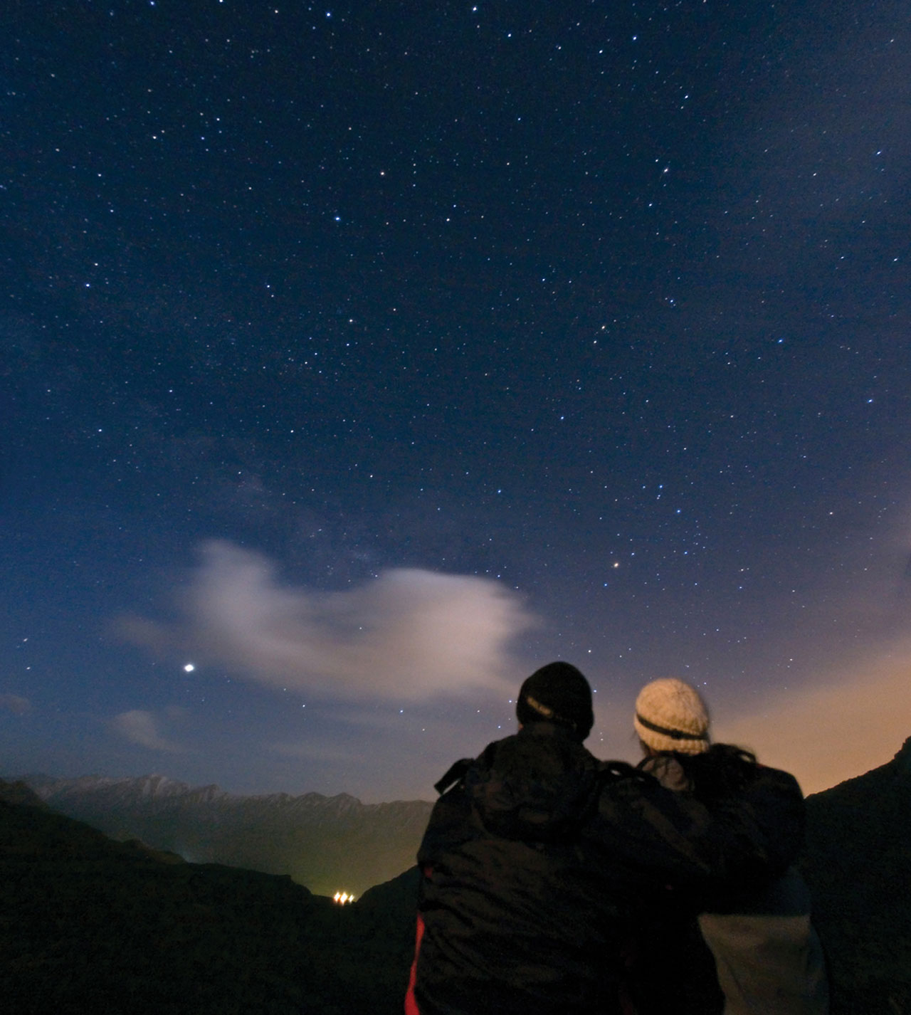A couple enjoys watching the night sky