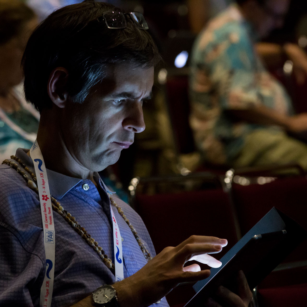 Man on tablet at the IAU XXIX General Assembly